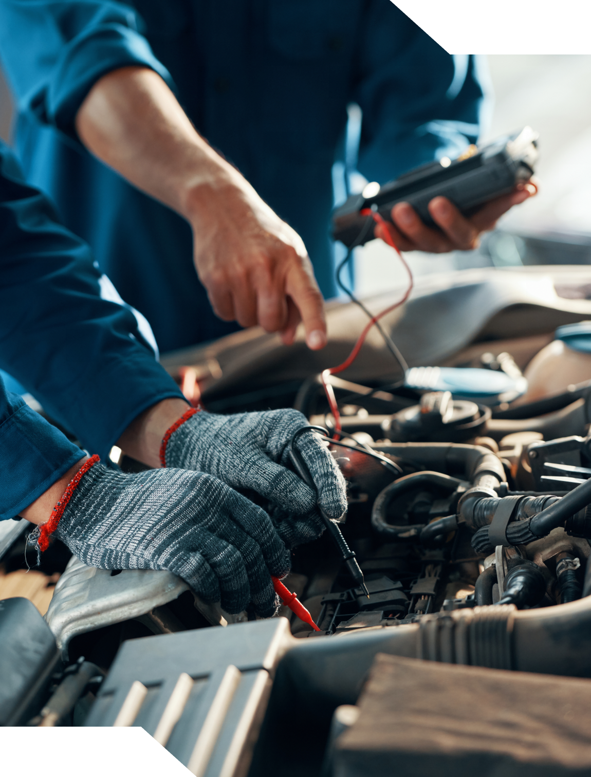 Mechanic using diagnostic tools on engine