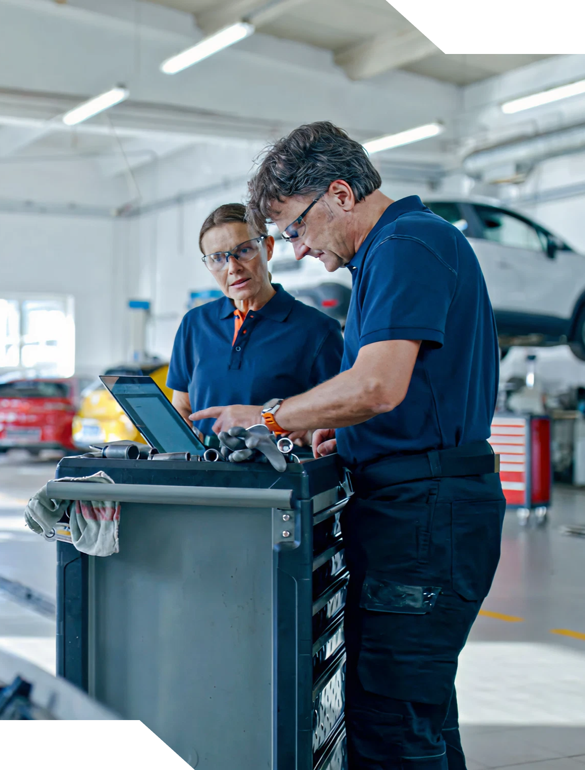 Two mechanics working with tools